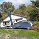A collapsed house is seen following a large landslide that occured after an earthquake hit Atsuma in Hokkaido.